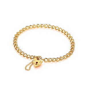 May include: A gold chain bracelet with a heart-shaped padlock charm. The charm has a keyhole and decorative details.
