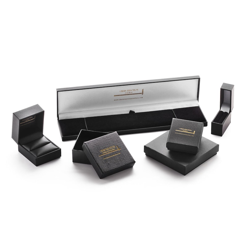 May include: Five black gift boxes with gold lettering. The boxes are all different sizes and shapes. The largest box is open and has a white interior. The boxes are all labeled "Craftsy Creations London".
