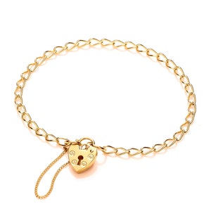May include: A gold chain bracelet with a heart-shaped padlock charm. The padlock has a keyhole and decorative details.