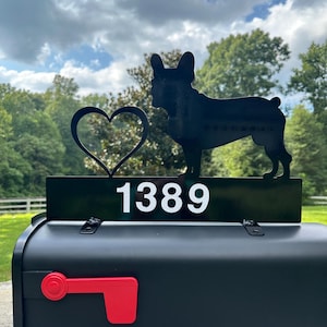 May include: Black metal mailbox topper with a silhouette of a French bulldog and a heart. The topper also includes the house number 1389.