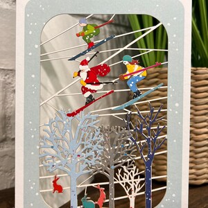 Santa and kids skiing laser cut card