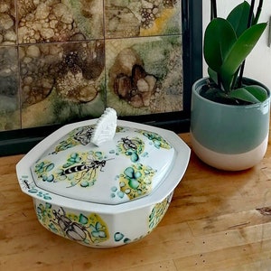 Porcelain vegetable dish with lid, insect decoration on yellow and turquoise background, designed by artist