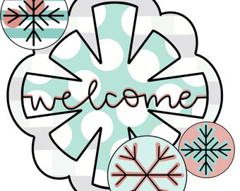 May include: A welcome sign with a snowflake design in teal and white with pink polka dots. The sign has the word "welcome" written in pink cursive. There are three smaller snowflake designs in the corners of the sign.