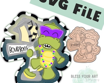 May include: A green cartoon alligator wearing purple sunglasses and a green, gold, and purple beaded necklace. The alligator is standing next to a street lamp with the word "Bourbon" on it. The image is a digital cut file for a craft project.