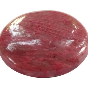 May include: A smooth, round, polished pink gemstone with a swirling pattern.