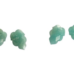 May include: Four green gemstone beads with a faceted, carved design. The beads are shaped like a stylized flower.