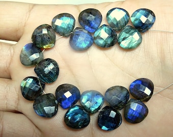 May include: A strand of faceted labradorite gemstone beads in shades of blue, green, and grey. The beads are heart-shaped and have a shimmering iridescent finish.