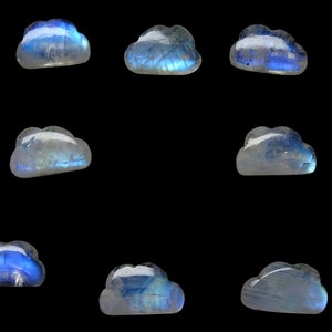 May include: Nine iridescent blue and white moonstone cloud shaped cabochons on a black background.