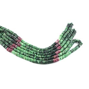 May include: A strand of green and pink gemstone beads. The beads are round and have a smooth, polished finish.