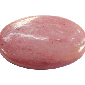 May include: A smooth, oval-shaped pink gemstone with a polished finish. The stone has a light pink color with subtle white streaks throughout.