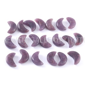 May include: A set of 18 purple crescent moon shaped gemstone beads. The beads are smooth and polished.