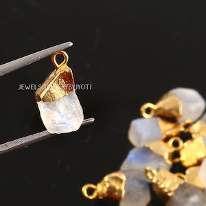 May include: Gold-plated rainbow moonstone pendant charms. The charms are irregular in shape and have a natural, raw look. They are perfect for jewelry making or adding a touch of sparkle to your crafts.