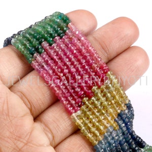 May include: A strand of colourful gemstone beads, including green, pink, yellow, and blue. The beads are faceted and have a round shape. The beads are strung on a clear thread.