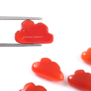 May include: Five red coral cloud shaped cabochons. The cabochons are smooth and polished. The cabochons are about 1 inch in size. JEWELSGALLERYBYJYOTI is printed on the largest cabochon.