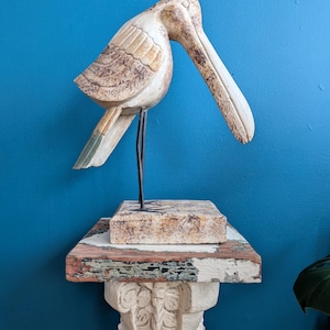 Wooden sculpture of a pelican