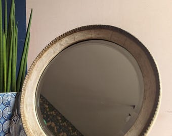 Early - mid 1900s round table mirror with cracked cream paintwork and decorative shaped edge