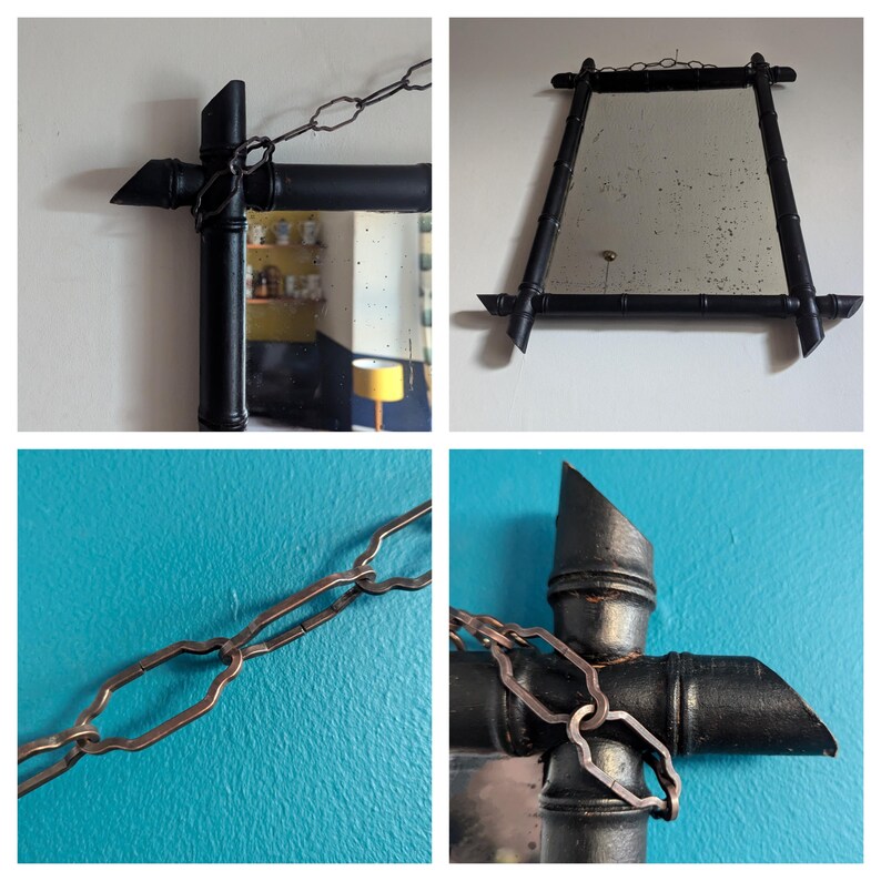 May include: A black bamboo framed mirror with a silver chain hanging from the top. The mirror is rectangular and has a beveled edge. The frame is made of individual pieces of bamboo that have been painted black.