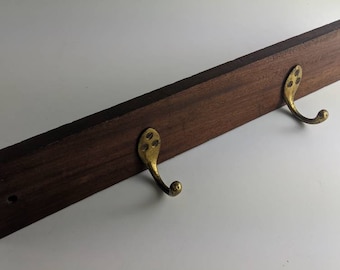 Vintage brass coat hooks on wooden plinth with fixings