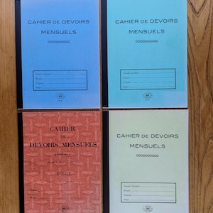 May include: Four blank school notebooks with red, blue and green covers. The covers have the text "Cahier de Devoirs Mensuels" which translates to "Monthly Homework Notebook".