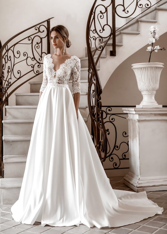 long sleeve lace wedding dress with satin skirt