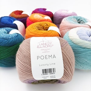 May include: A selection of vibrant yarn skeins, with a prominent light brown skein labelled "POEMA Luxury Line" from Laines du Nord, Made in Italy. Other skeins show hues of blue, green, orange, purple, and pink. The yarn is tightly wound and appears soft.