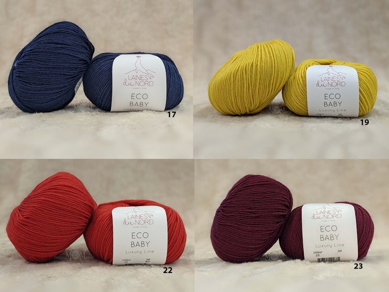 May include: Four skeins of yarn in different colors: navy blue, yellow, red, and burgundy. Each skein has a label that reads "Laines du Nord Eco Baby Luxury Line" with a corresponding color number.