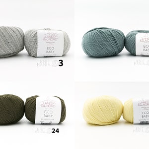 May include: Four skeins of yarn in different colors: gray, blue-green, olive green, and yellow. Each skein has a label that reads "Laines du Nord Eco Baby Luxury Line".