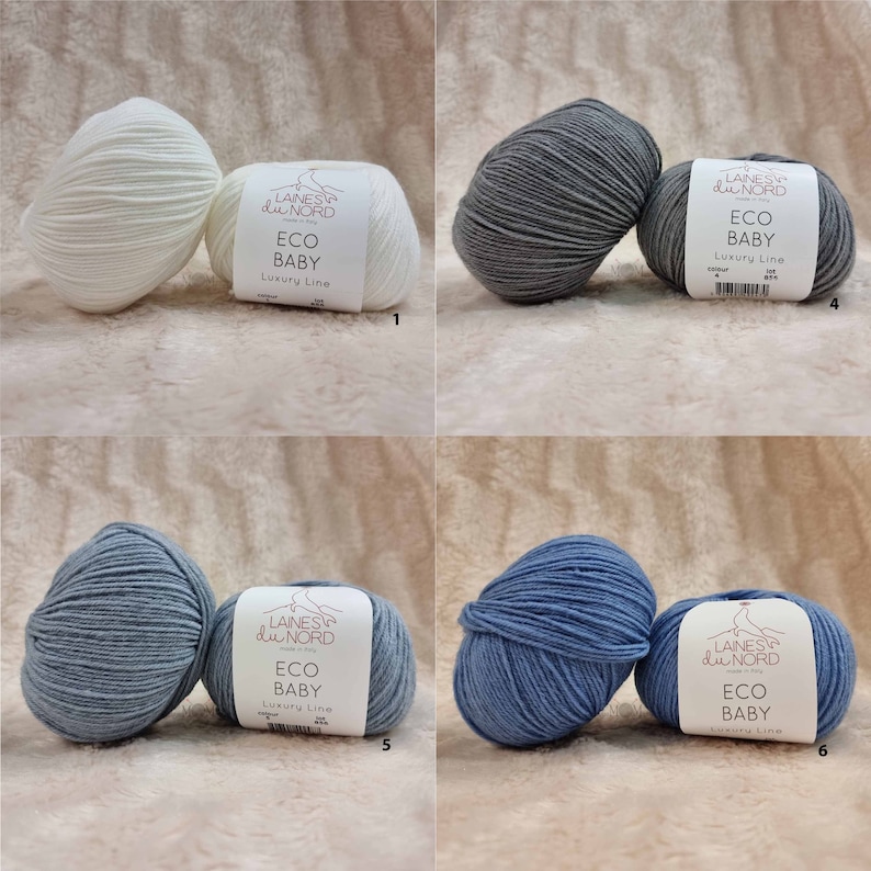 May include: Four balls of yarn in different colors: white, gray, light blue, and dark blue. Each ball has a label that reads "Laines du Nord ECO BABY Luxury Line".