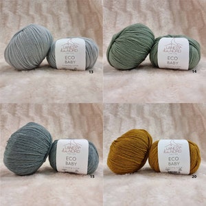 May include: Four balls of yarn in different colors: light blue, green, blue-green, and mustard yellow. Each ball has a label that reads "LAINES du NORD ECO BABY Luxury Line" with a number underneath.