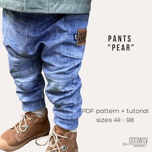 May include: Blue denim pants for children with a patch that says "Wilder Kerl". The pants have a relaxed fit and are designed for comfort. The image includes the text "PANTS "PEAR"" and "PDF pattern + tutorial sizes 44 - 98".