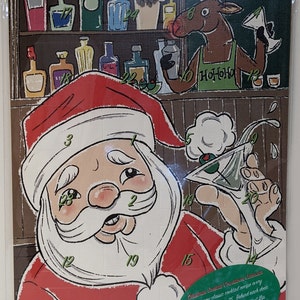 May include: A Christmas advent calendar featuring a cartoon Santa Claus holding a martini glass. Each day has a numbered door behind which is a new cocktail recipe. The text on the calendar reads "Christmas Cocktail Countdown Calendar. Try a new classic cocktail recipe every day until December 25. Behind each door is a delicious libation idea - just flip to the back for the recipe."