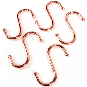 May include: Five rose gold S-shaped hooks. These hooks are great for hanging kitchen utensils, towels, or other items.