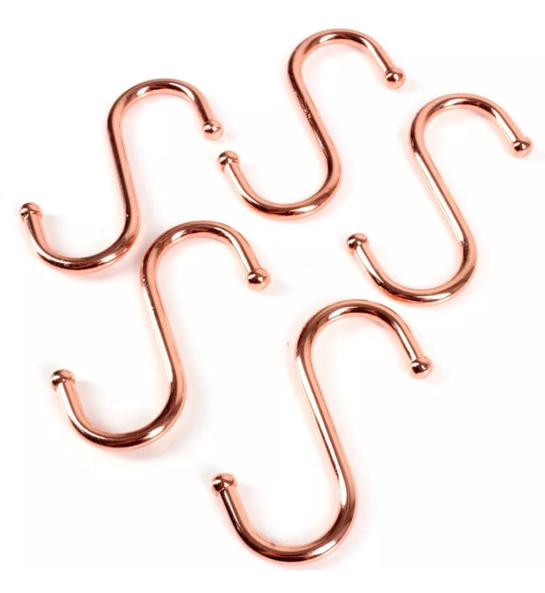 May include: Five rose gold S-shaped hooks. These hooks are great for hanging kitchen utensils, towels, or other items.