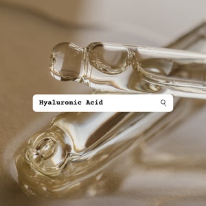 May include: Two clear glass vials of hyaluronic acid serum, one lying on top of the other, with a search bar above them that reads "Hyaluronic Acid".