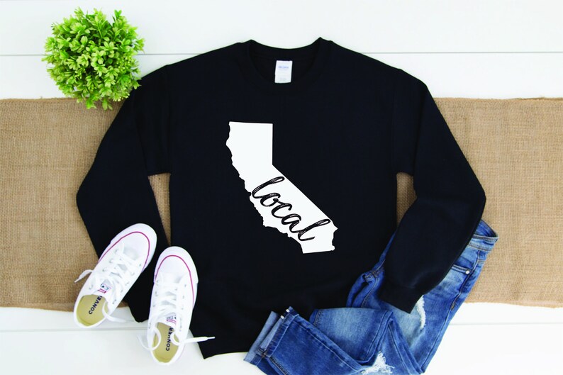 May include: Black sweatshirt with a white outline of the state of California and the word "local" written inside the outline.