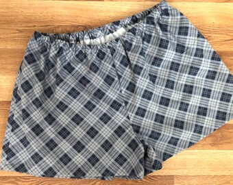 May include: Gray and white plaid shorts with an elastic waistband.