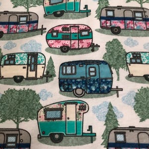May include: A repeating pattern of colorful vintage camper trailers on a white background. The trailers are decorated with floral patterns and various colors, including pink, teal, and blue. Trees and clouds are also featured in the design.