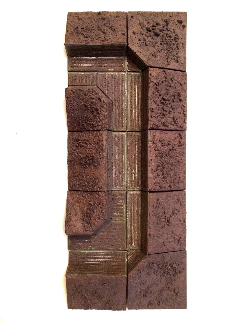 Pode incluir: Um conjunto de azulejos texturados marrons e verdes que podem ser usados para criar um modelo em miniatura de uma trincheira ou bunker.