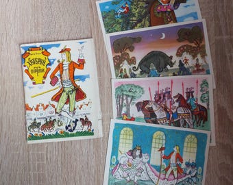 May include: A set of five vintage postcards featuring illustrations of a man in a blue and red costume, a rhinoceros, a group of people riding horses, and a couple in a castle. The postcards are in Russian and feature the text "Храбрый портной".