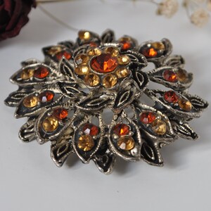 1970- Round brooch with floral ornament, Czech yellow crystals