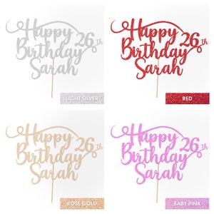 May include: Four cake toppers with the text "Happy 26th Birthday Sarah" in different glitter colors: light silver, red, rose gold, and baby pink.