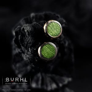Handmade Green Koto Wood & Heat-Colored Stainless Steel Stud Earrings – A One-of-a-Kind Blend of Nature & Metal
Add an earthy yet bold touch to your style with these handmade Green Koto wood stud earrings, set in heat-colored stainless steel that shifts between gray, green, gold, copper, and blue hues—each pair uniquely its own. The vibrant green wood grain contrasts beautifully with the iridescent metal bezel, making these earrings a stunning fusion of organic and industrial aesthetics.