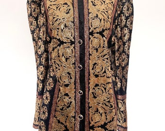 May include: A black velvet jacket with gold floral embroidery and a button-up front. The jacket has long sleeves with puffed shoulders and a fitted silhouette.