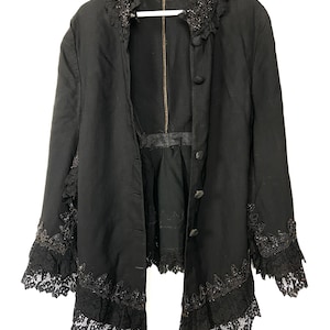 Antique 19th century Victorian black wool cape. Embellished Goth style mourning caplet with cotton lace, tassels and jet beading.