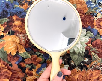 Vintage 1960s Celluloid or Bakelite beveled edge hand held mirror. Retro  mirror. Round pastel yellow mirror. Vanity table mirror. Pinup.