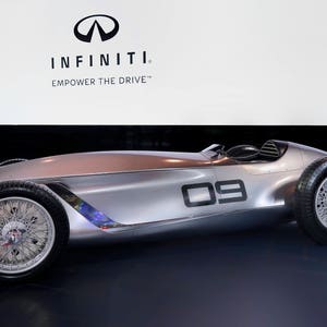 May include: A silver Infiniti concept car with the text "INFINITI. EMPOWER THE DRIVE" on the wall behind it. The car has a large number "09" on the side.