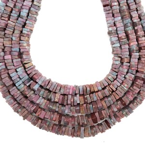 May include: A strand of pink and gray gemstone beads, each bead is a rectangular shape with a slightly irregular cut.