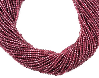 May include: A strand of deep red garnet beads, faceted and strung together. The beads are small and uniform in size, creating a smooth and elegant look.