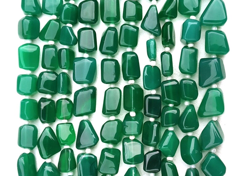 May include: A strand of green agate gemstone beads, each bead is a unique, irregular shape. The beads are strung on white thread.