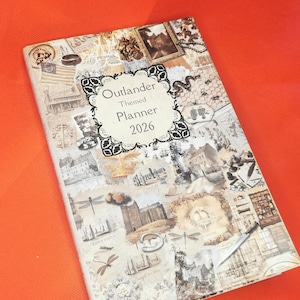 May include: A 2026 Outlander themed planner with a collage cover featuring vintage imagery. The design includes castles, dragonflies, and text elements. The planner is set against an orange backdrop.